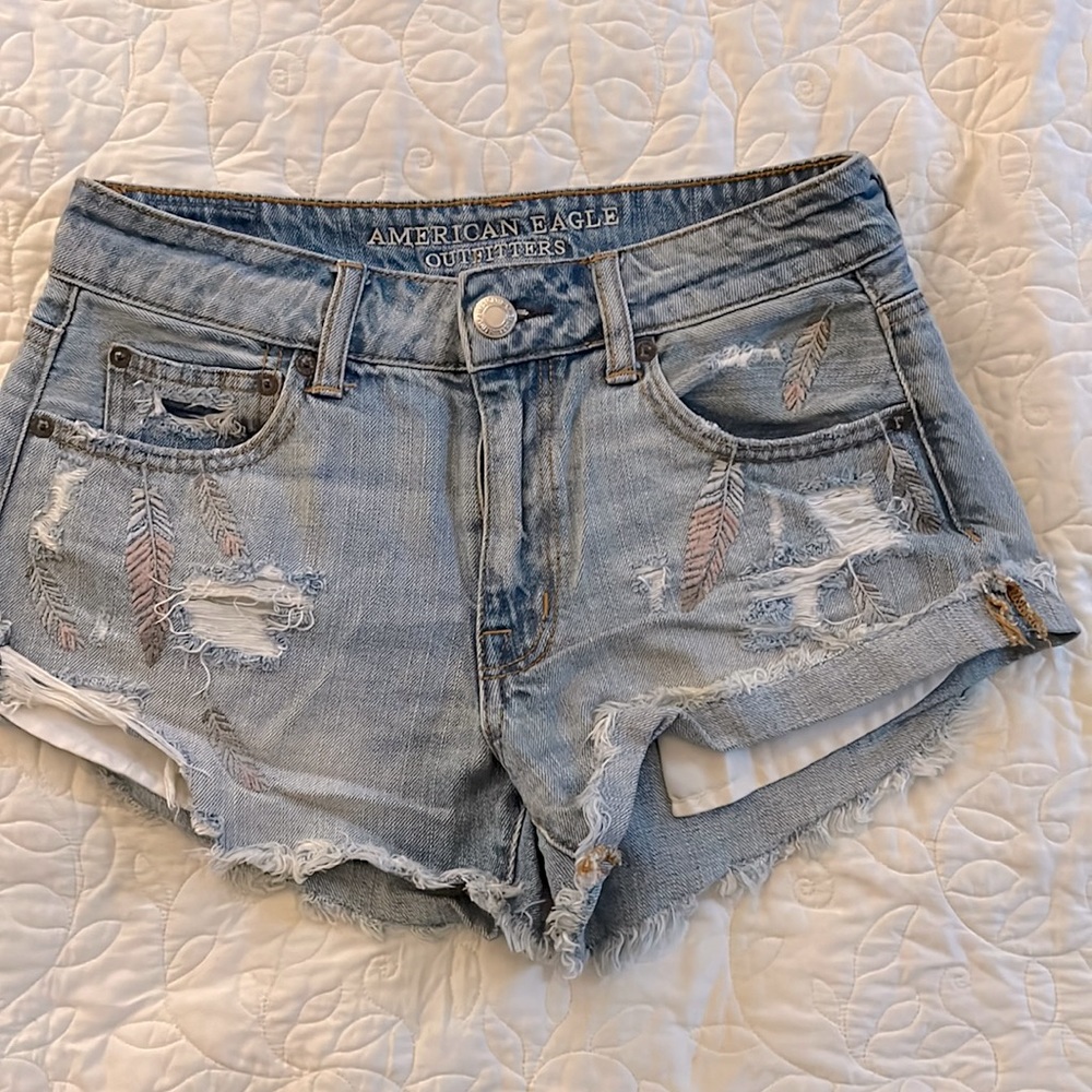 Embroidered distressed denim shorts